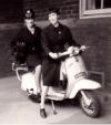 Bev, as District Midwife, on scooter
